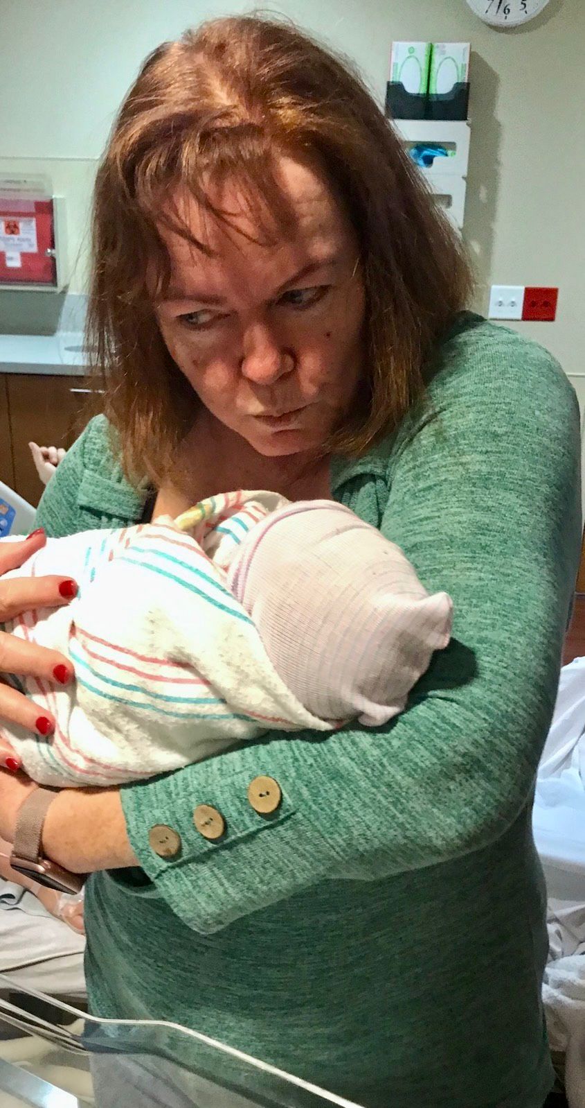 Sandy kissing a newborn baby