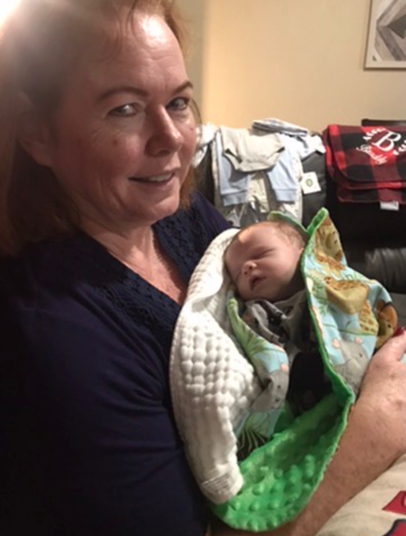 Sandy holding a sleeping grandchild