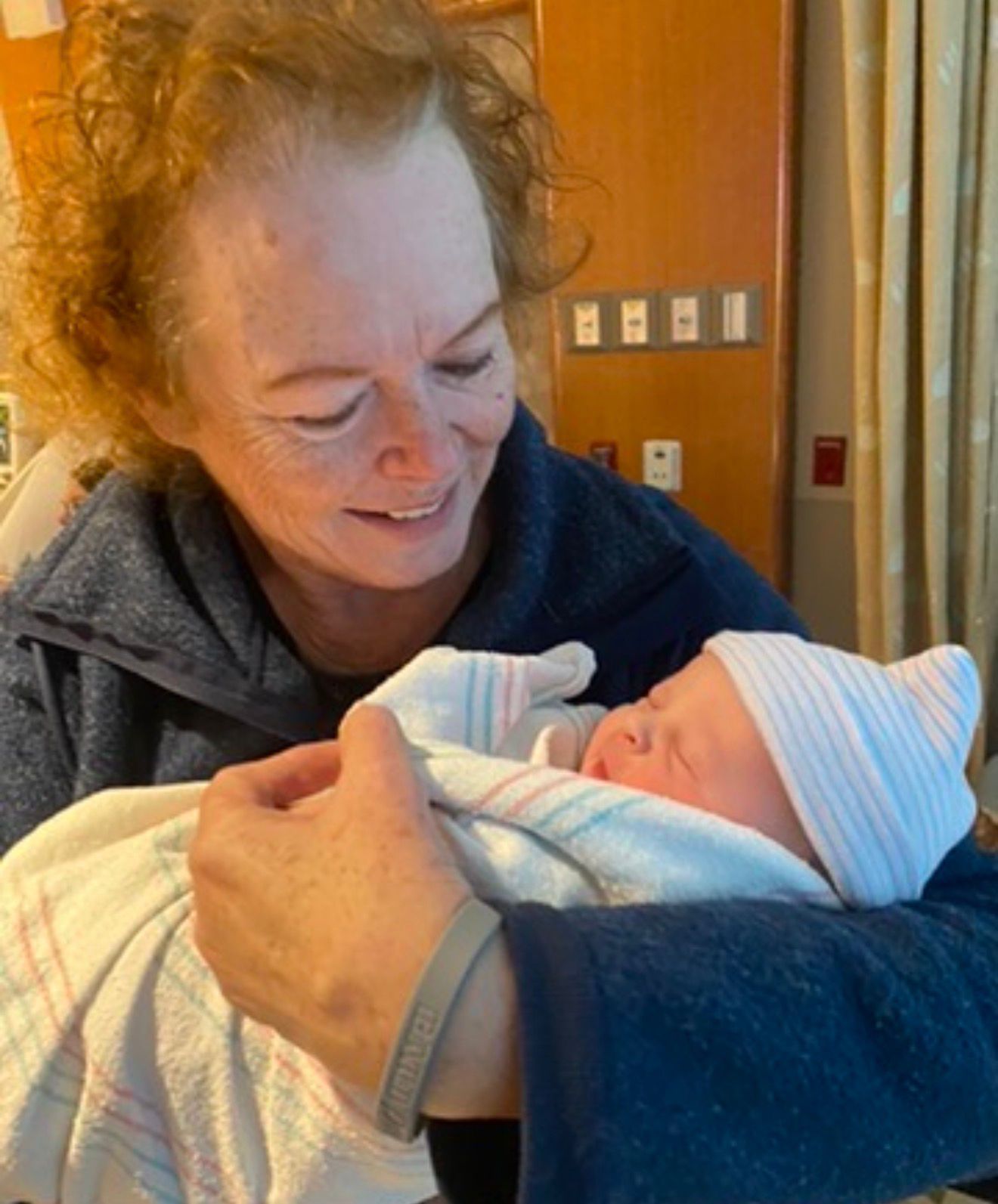 Sandy looking lovingly at a newborn