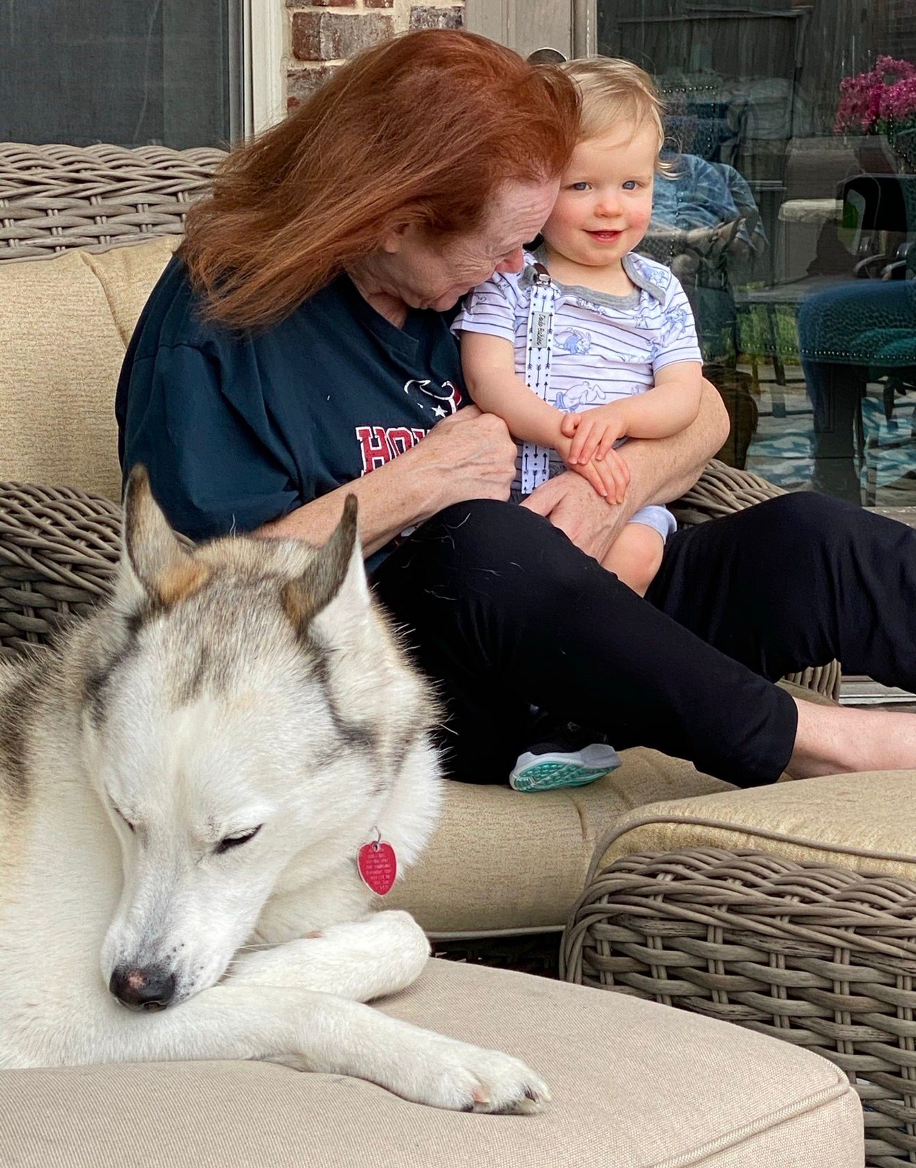 Sandy with a grandchild and a beloved family dog