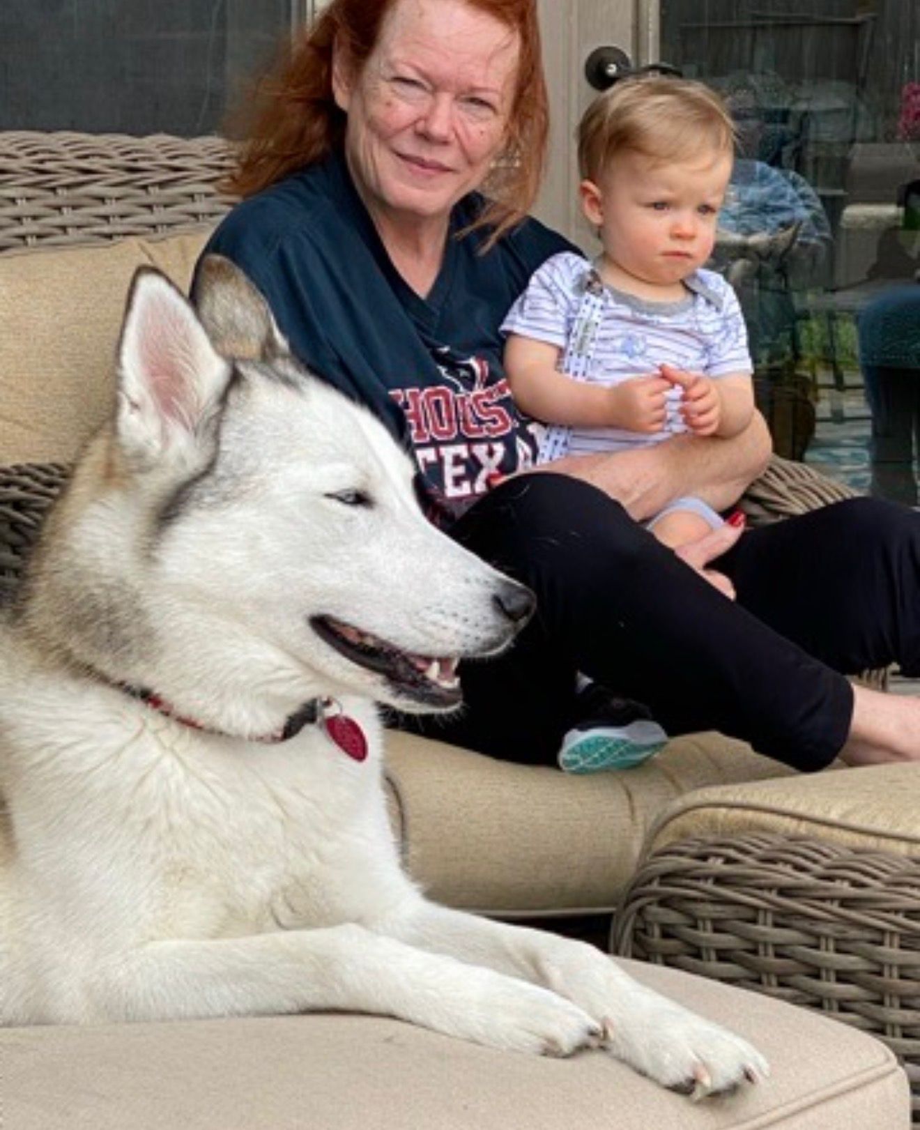 Sandy, a grandchild, and the family dog relaxing together