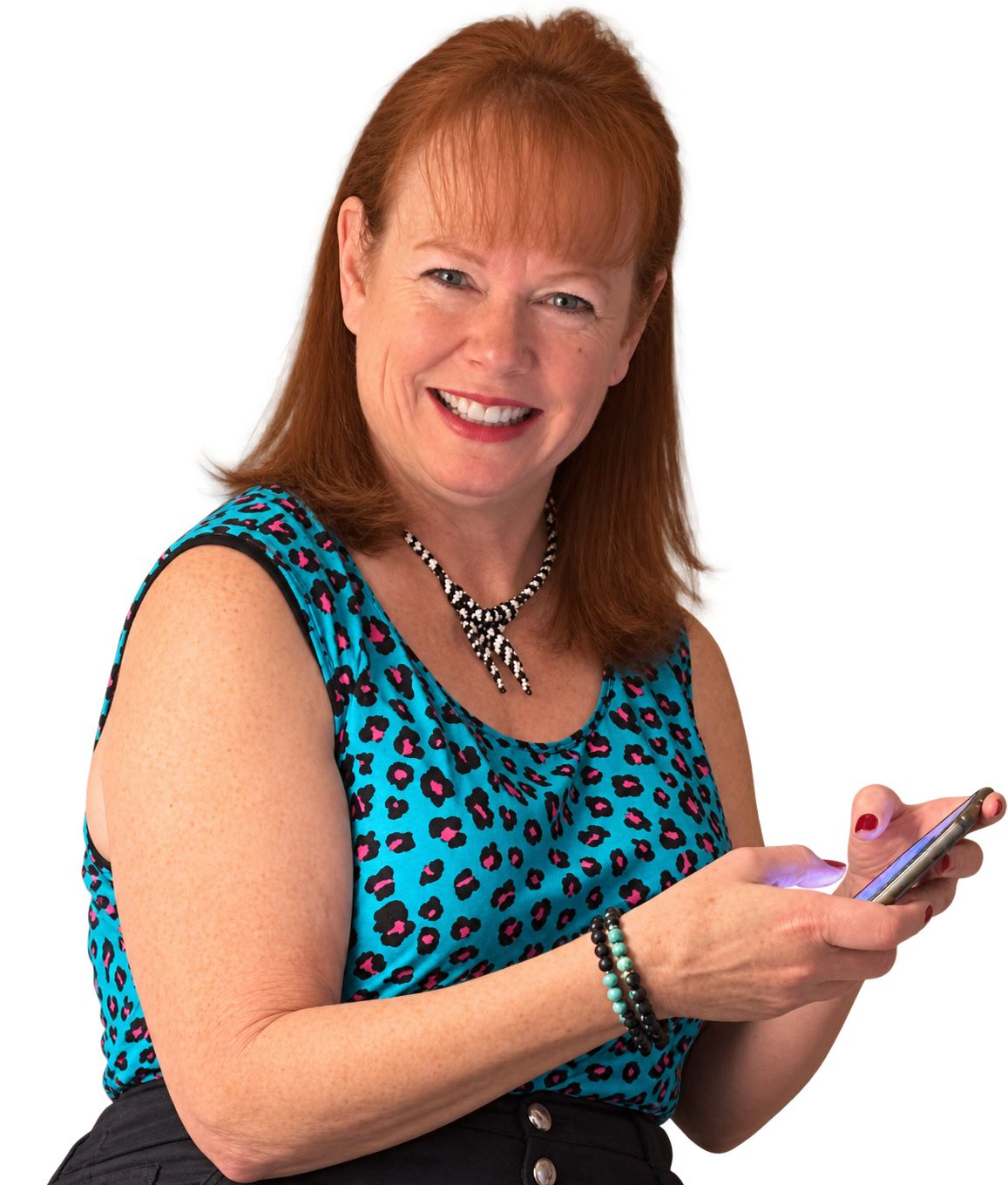 Sandy smiling while holding her phone